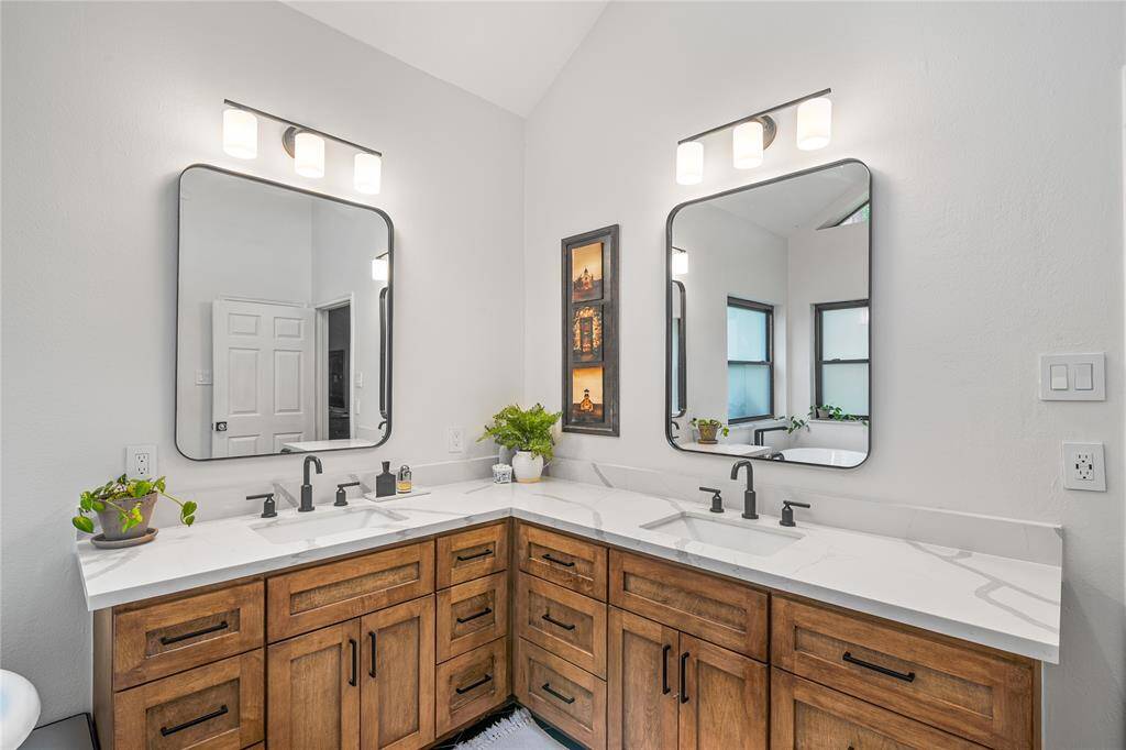 The primary bathroom has two vanities, allowing for even sharing.