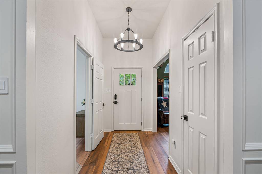 Step into a stunning entryway featuring elegant flooring and soaring ceilings that create a grand first impression.