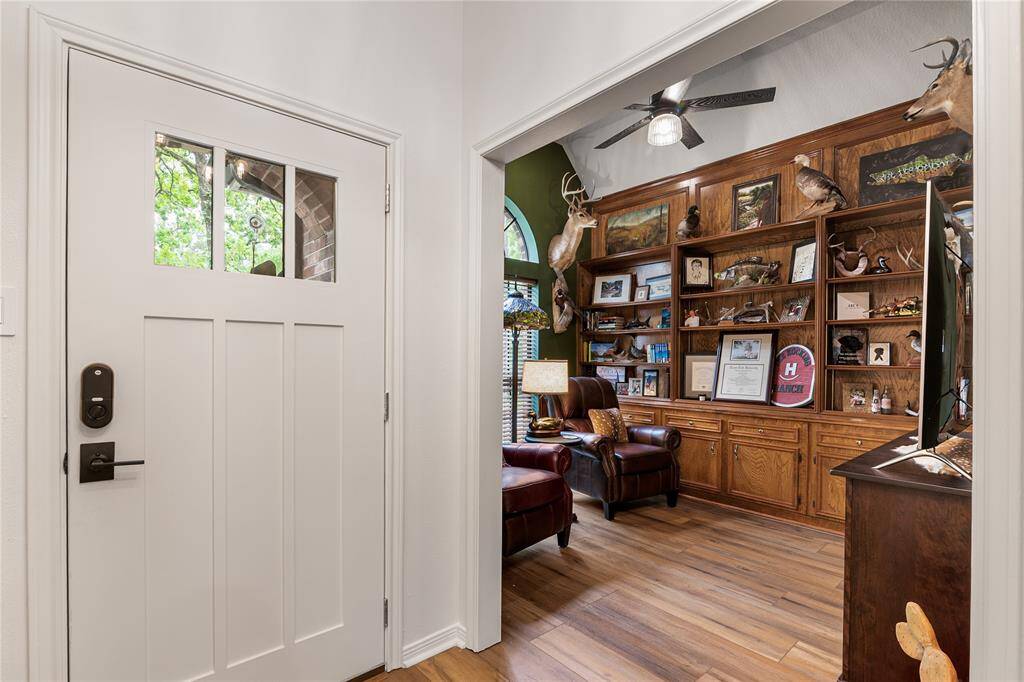 Just off the foyer, a dedicated home office with custom built-in shelving offers a quiet, stylish space for work or study.