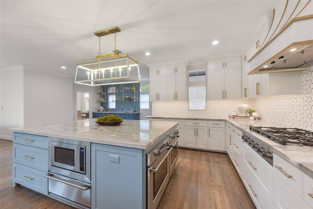 Gorgeous pendant and chandelier lighting installed in 2023. Kitchen opens to the living area and bar which is perfect for entertaining.