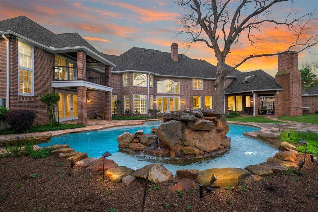 The backyard sits on almost half an acre of land and has a large pool and yard perfect for entertaining.