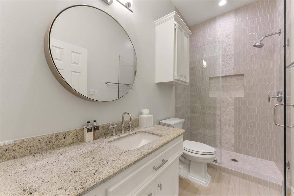 Remodeled guest suite features designer tile and hardware.