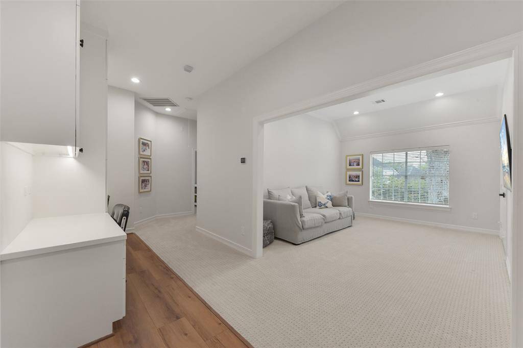 The desk area opens to one of the 2nd-floor living spaces overlooking the pool.