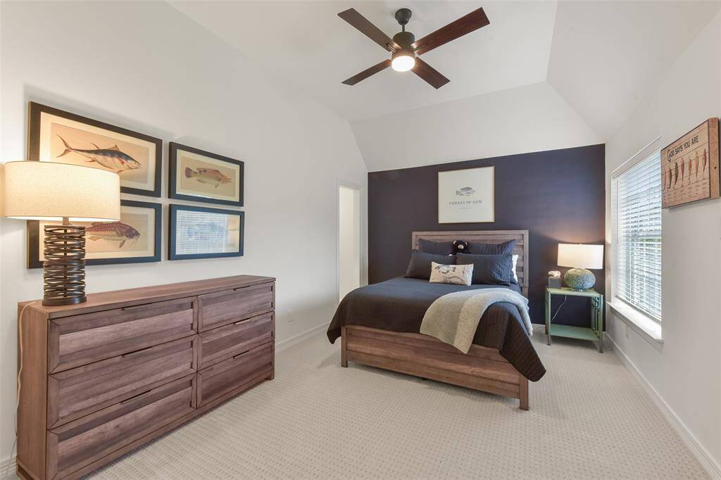 Secondary bedroom with vaulted ceiling.