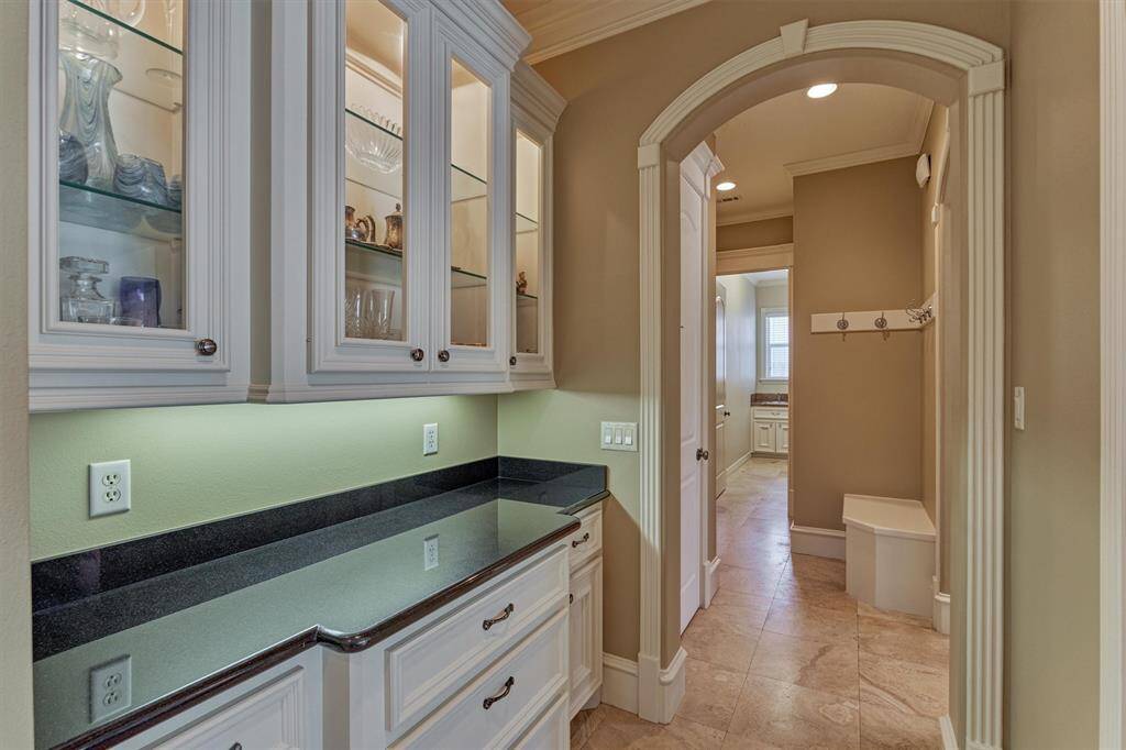 Beautiful glass-paneled butlers pantry with accent lighting - a perfect venue for meal or bar service!
