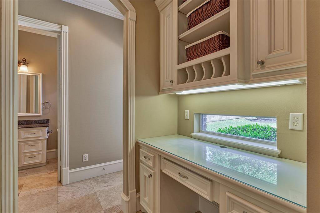 Passthrough from kitchen features a built-in desk and organizer.
