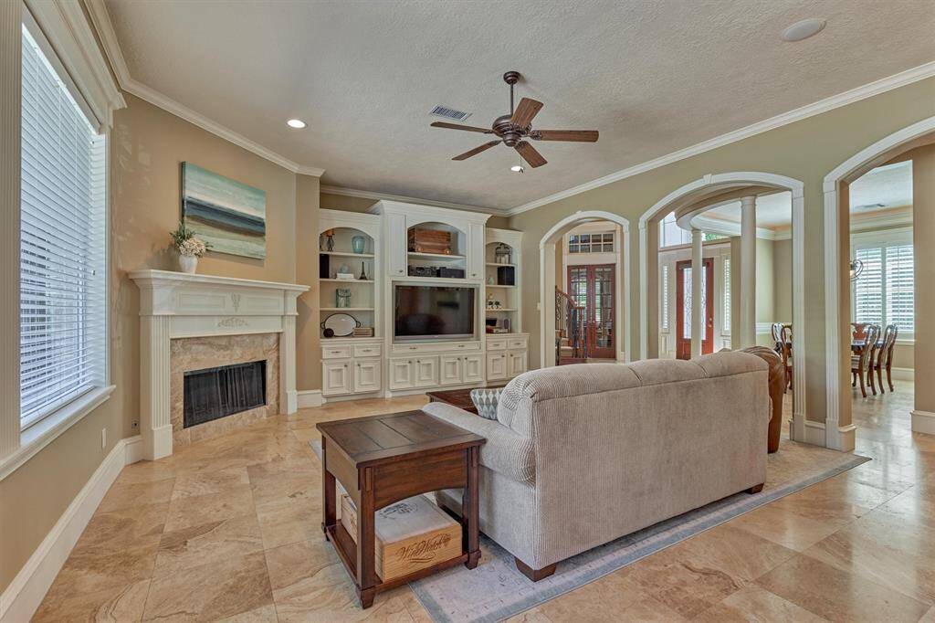 Spacious den showcases a fireplace and a wall of built-ins.