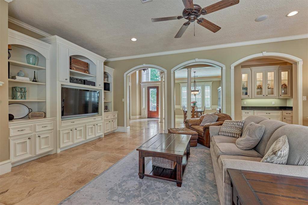 Stunning sightlines through the arched openings provide a seamless flow throughout the main living areas. Note: the butler's pantry - connecting the dining room and kitchen.