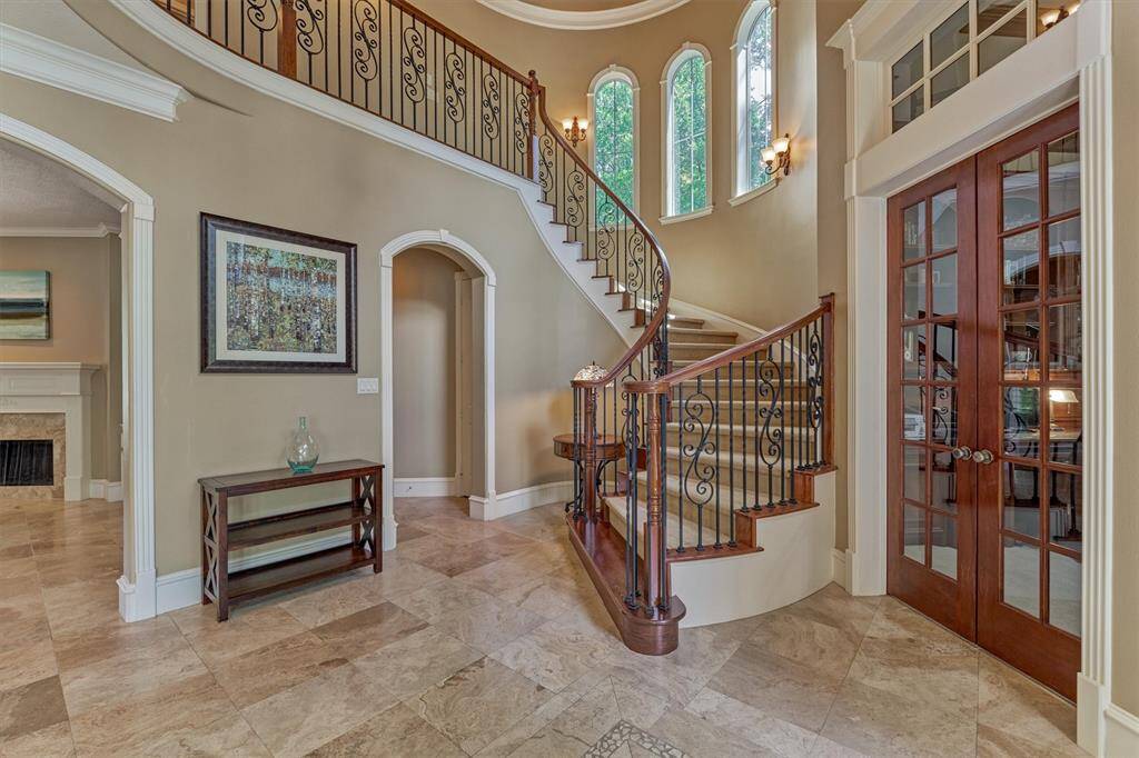 Working our way back to a secluded entry to the owner's retreat via private hall off the grand foyer. Note the architecturally rich arched windows under the turret roof crowned with a rounded pop-up ceiling.