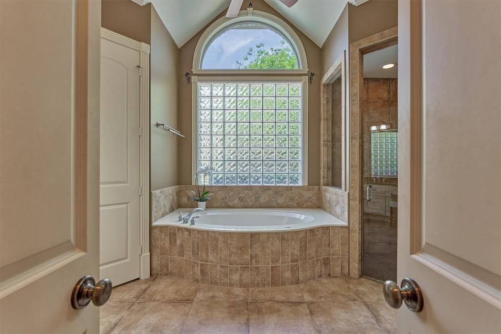 Step inside the luxurious owner's retreat bathroom with vaulted ceiling!