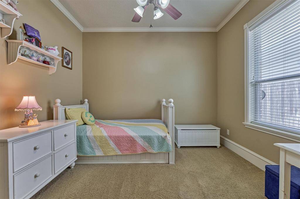 Spacious secondary bedroom down with en-suite bathroom, conveniently offset from the main living area and primary suite for ultimate privacy.
