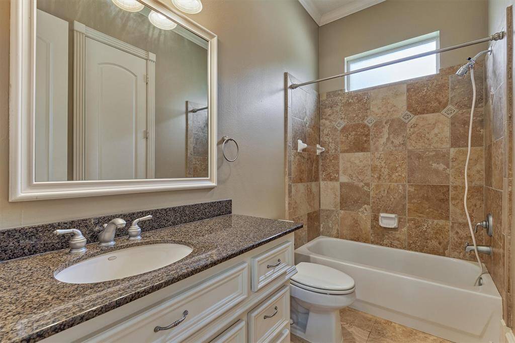 En-suite bath for downstairs secondary bedroom and also near the exterior door to serve dual purpose as a pool bath with separate hallway door - genius in design!