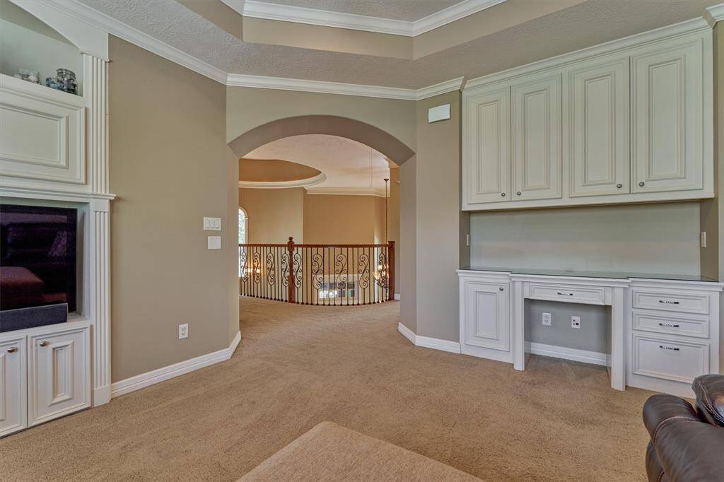 Built-in desk and cabinetry provides lots of organization and storage space in the game room.