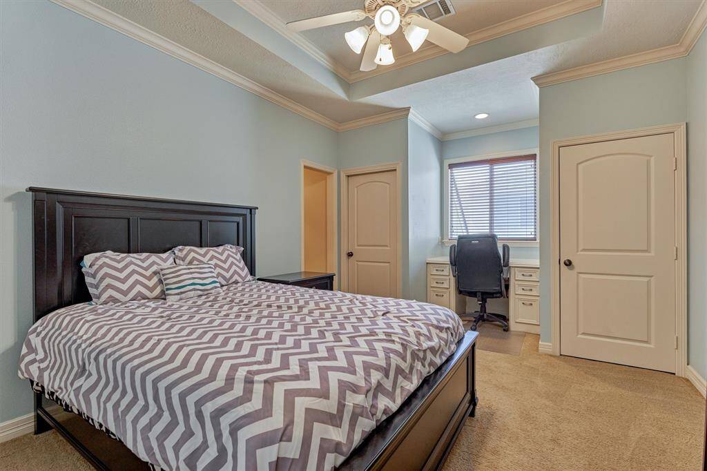 Secondary bedroom #3 is spacious with built-in desk, walk-in closet and trayed ceiling.