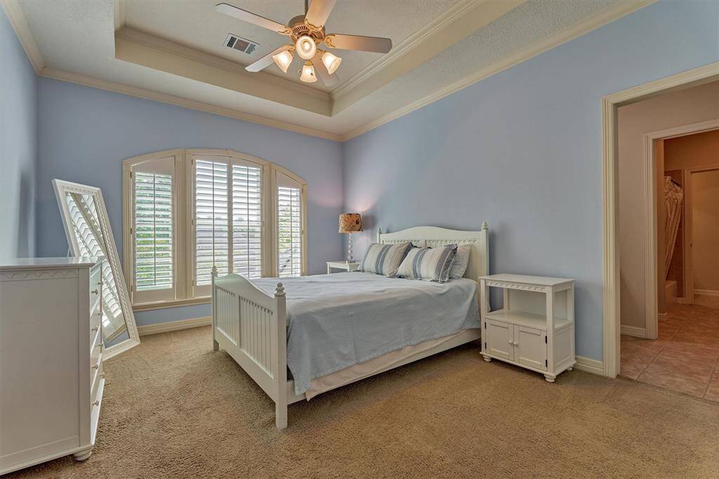 Secondary bedroom #4 is spacious with walk-in closet, trayed ceiling, and plantation shutters.