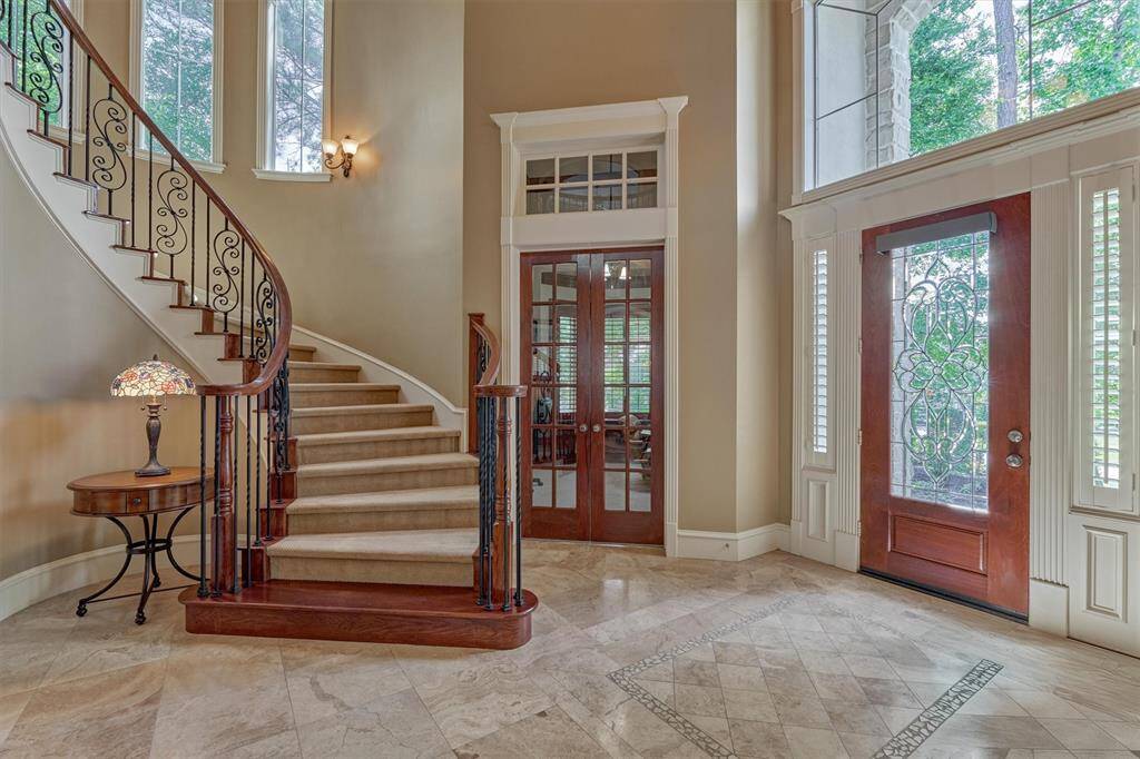 Talk about an entrance! French door entryway leads to paneled study.