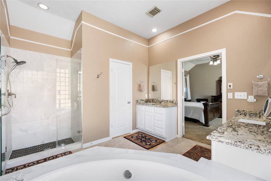 Designed with relaxation in mind, the primary bath is truly a tranquil setting perfect for unwinding. Whether you're soaking in the tub after a long day or enjoying the spacious layout, this serene retreat invites calm and comfort at every turn.