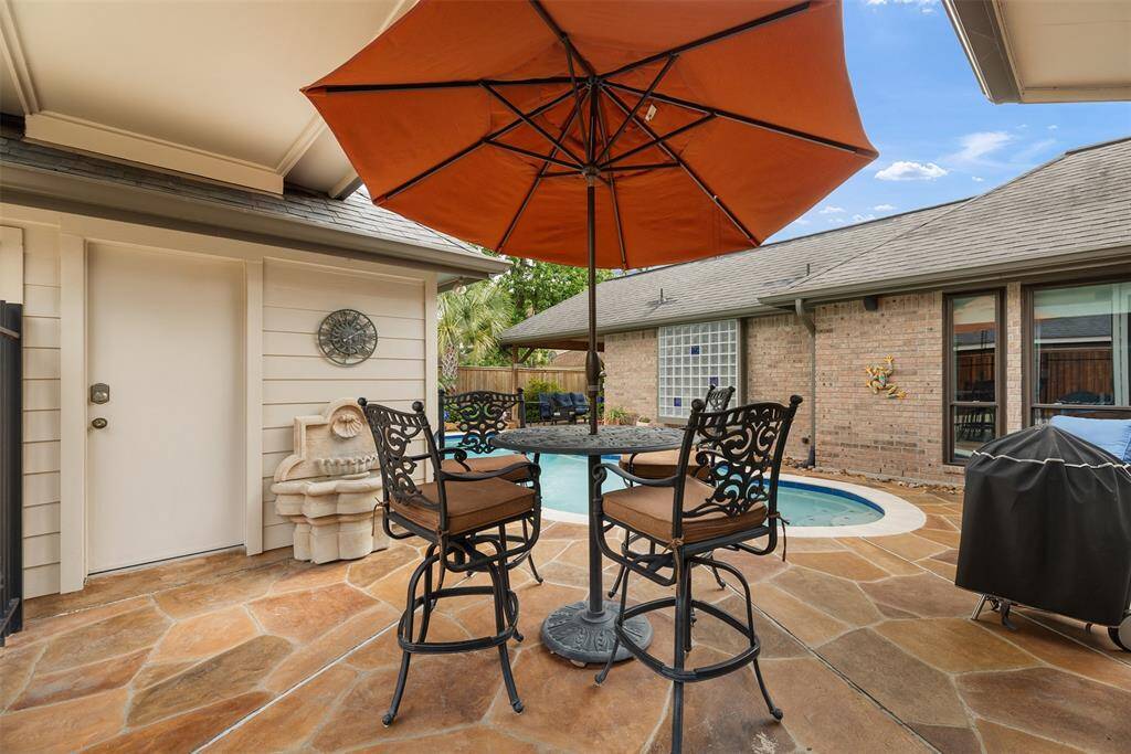 This charming backyard patio offers the perfect spot for outdoor relaxation and entertaining. Surrounded by a mix of brick and siding, the space is anchored by a cozy seating area and a refreshing pool, creating a welcoming retreat to enjoy peaceful moments or lively gatherings.