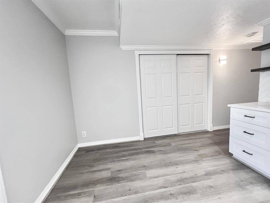 View from front door with closets on both sides of the hallway