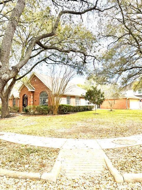 Side view of large corner lot of single story all brick home