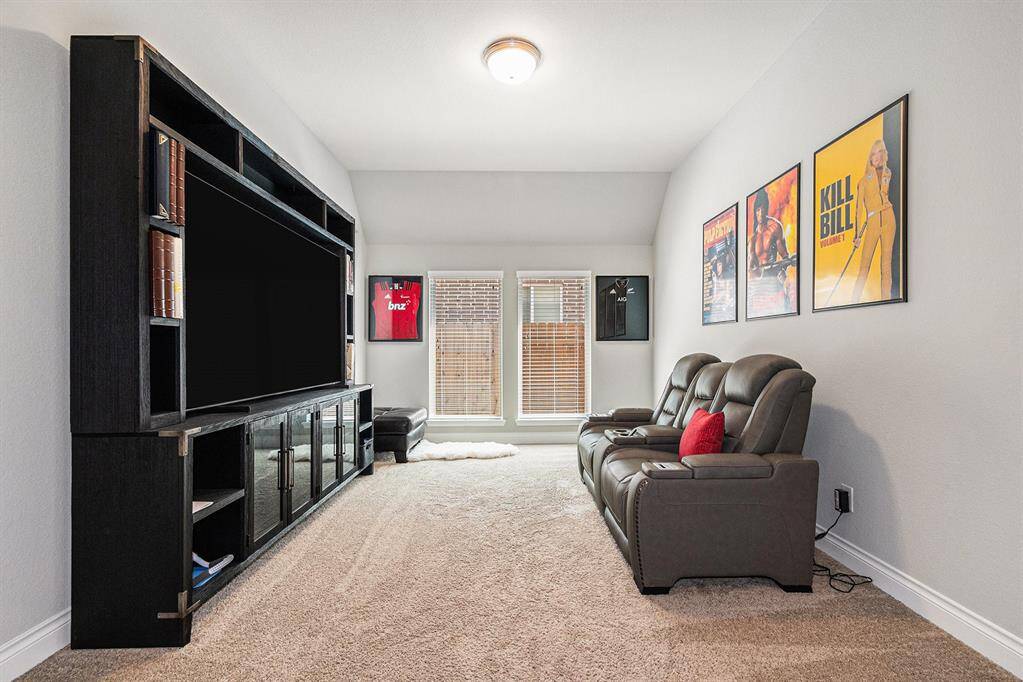 Large game / media room off extended entry with 8' French Doors.