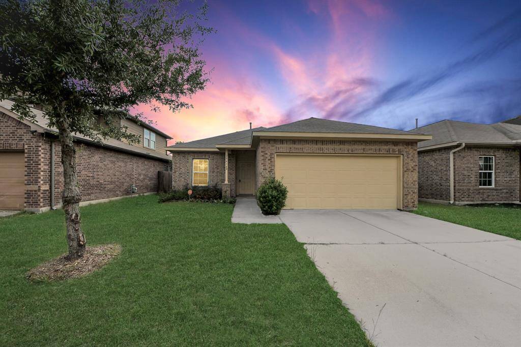 Charming single-story home with a brick exterior and a two-car garage. Features a well-maintained front lawn and a cozy porch area, ideal for a welcoming entrance.