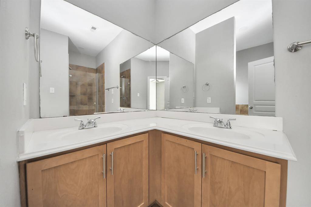 Luxurious primary ensuite featuring dual sinks and elegant cabinetry, perfect for a serene retreat.
