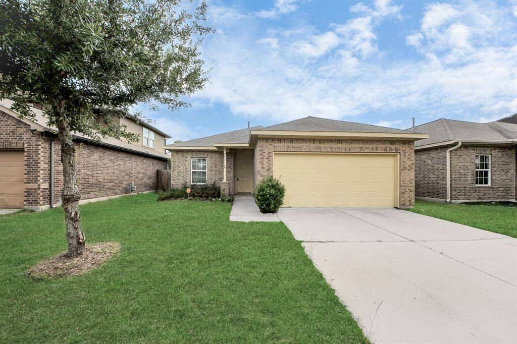 Charming single-story home with a brick exterior and a two-car garage. Features a well-maintained front lawn and a cozy porch area, ideal for a welcoming entrance.