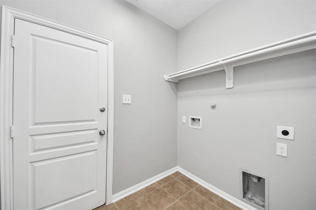 Convenient laundry area with direct garage access for easy transitions.