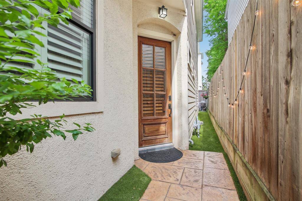 Walk through path gate to front door.