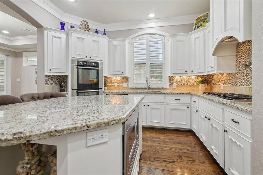 To the left find this stunning kitchen blends functionality with timeless elegance.