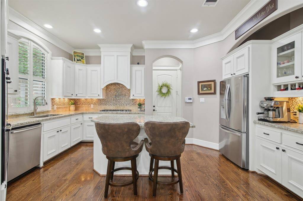 A spacious breakfast island anchors the room—ideal for casual meals, morning coffee, or prepping for your next dinner party.