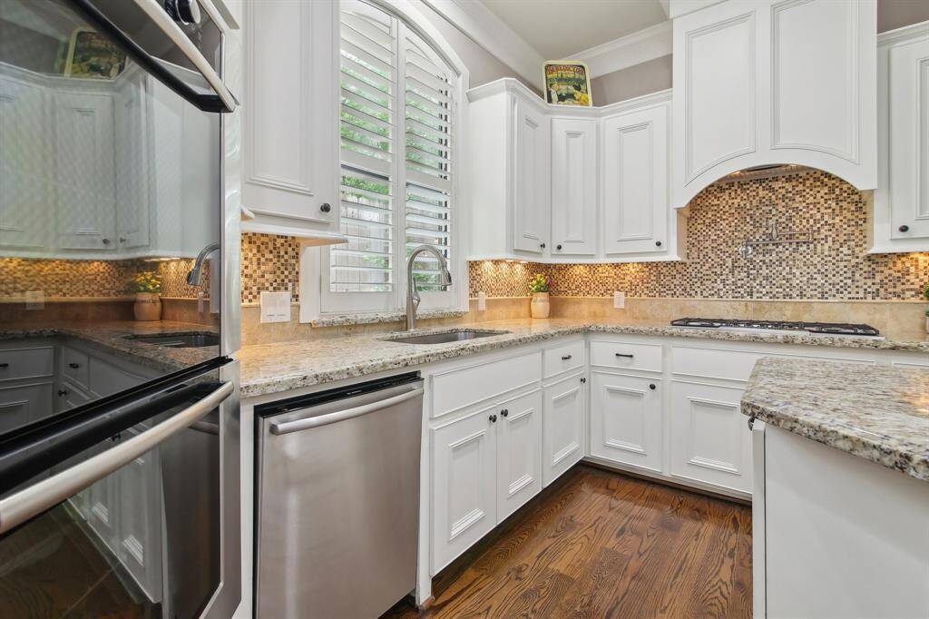 Double ovens provide ample cooking capacity, while the deep farmhouse sink adds both charm and practicality.