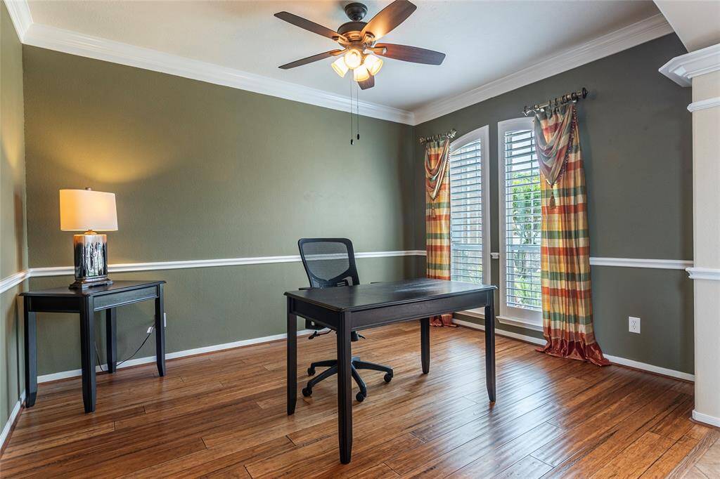 Spacious home office with bamboo flooring, crown molding and Plantation shutters.