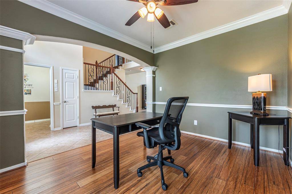 Home office with crown molding and chair-rail molding.