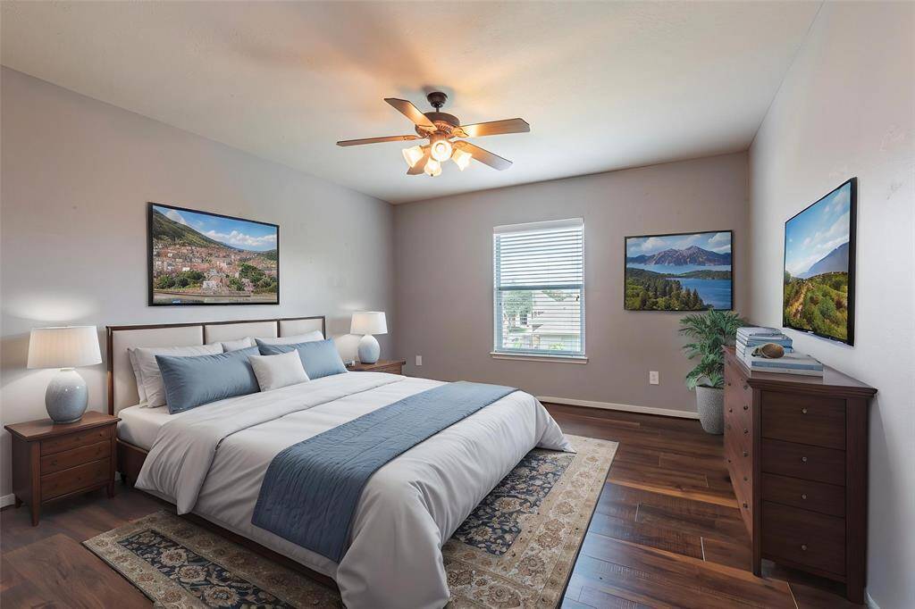 Virtually staged 2nd bedroom with wood flooring and walk-in closet.
