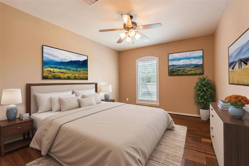 Virtually staged 4th bedroom with Plantation shutters, wood floors and ceiling fan.