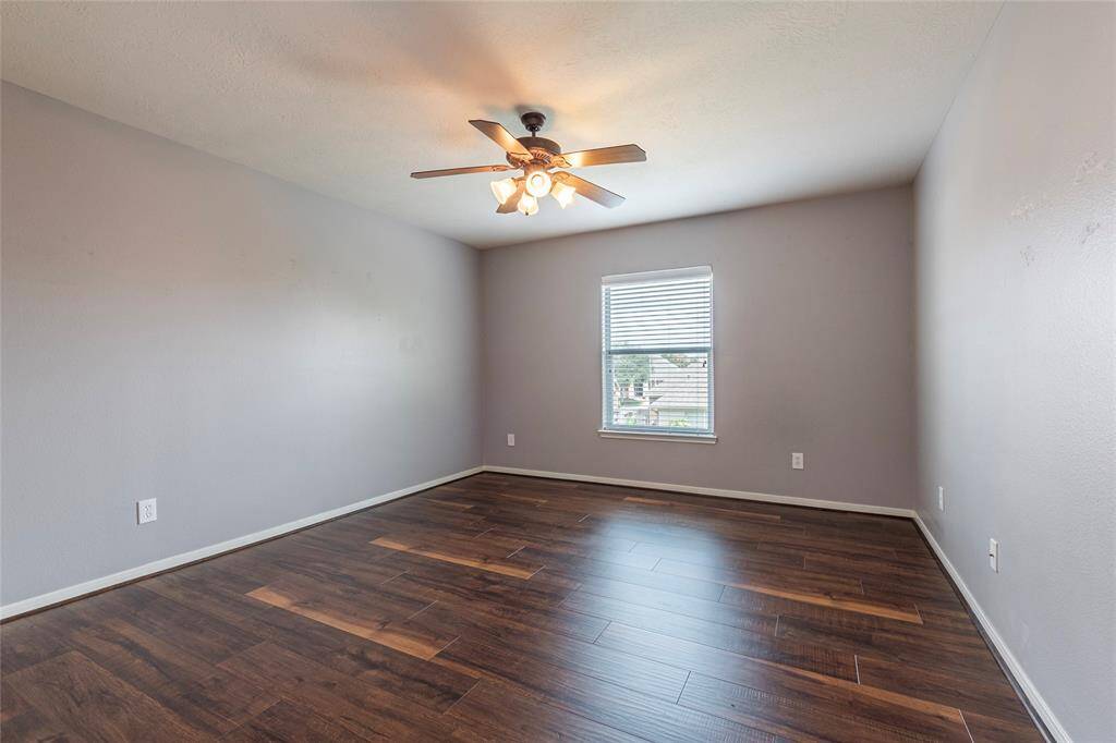 2nd bedroom is spacious with wood flooring.