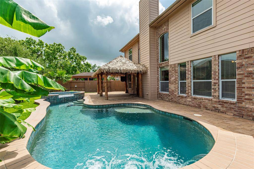 Just in time for Summer! Private backyard with only 1-story homes around. Another view of the large swimming pool with hot tub and water features.