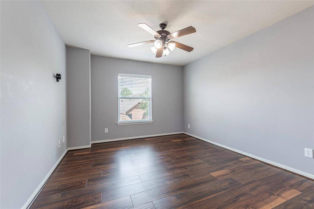 3rd bedroom is also spacious with wood flooring and ceiling fan fixture.