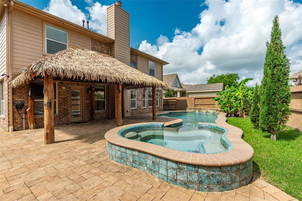 Beautiful sparkling swimming pool and heated spa in the backyard area.