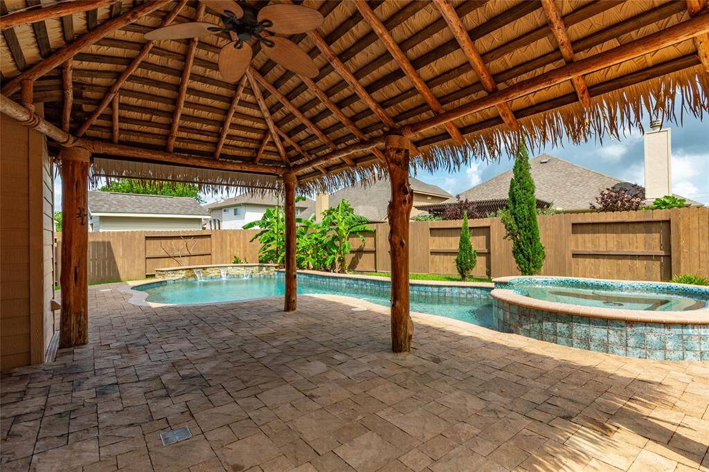 Stay cool in the shade under the custom palapa and patio area with ceiling fan and outdoor TV outlet.
