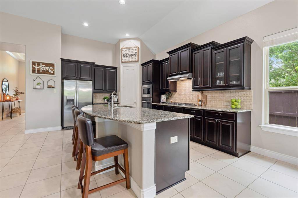Tall ceilings/windows illuminate living/kitchen naturally