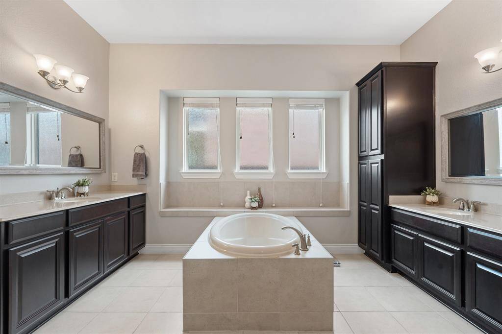 Primary ensuite with double sinks, free standing tub & XL shower