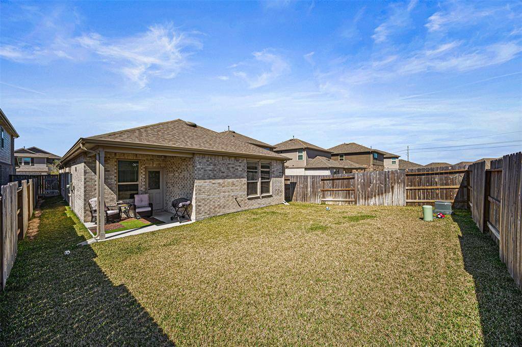 Enjoy this backyard with a covered patio.