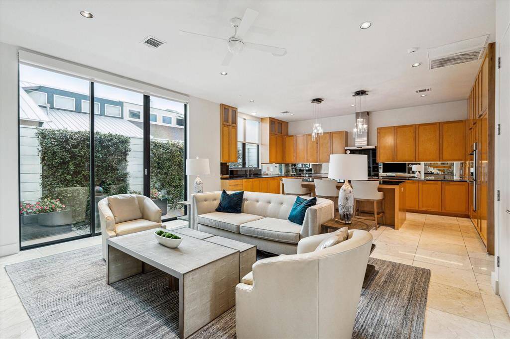 Open floor plan! Family room looking toward the kitchen and side patio.  Side patio is also professionally landscaped with fountain and Japanese Blueberry trees.