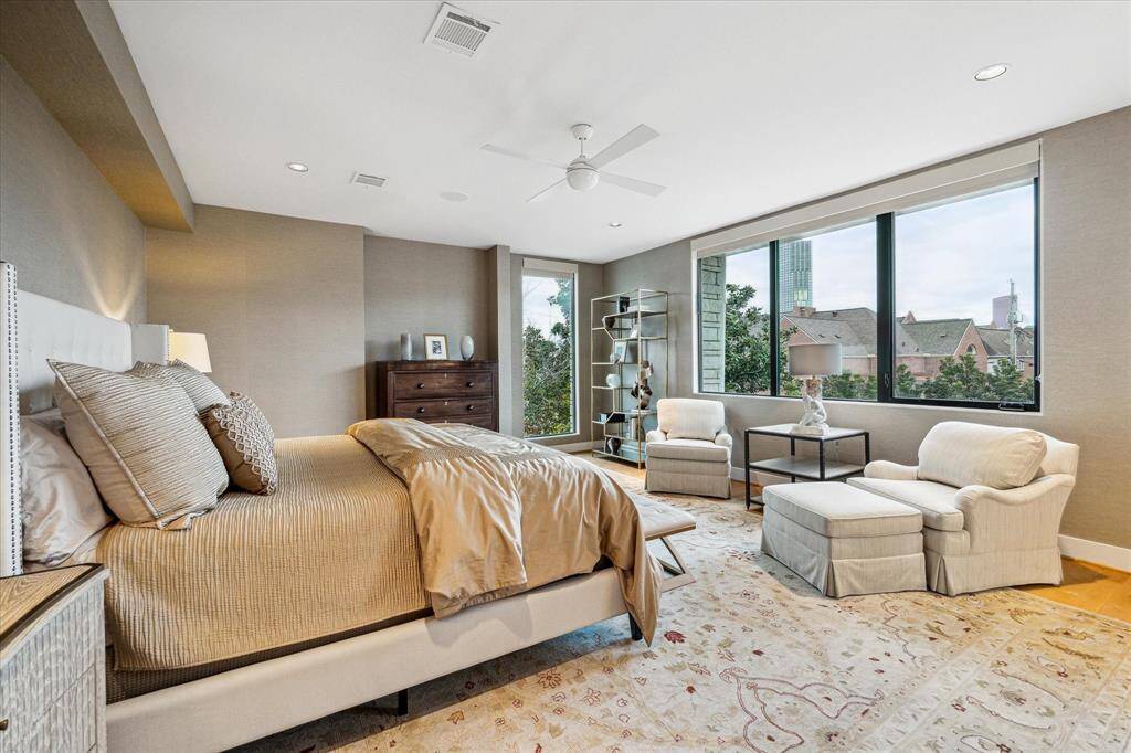 Large primary bedroom is located on the second floor. Hardwood floors - Custom Wallpaper.