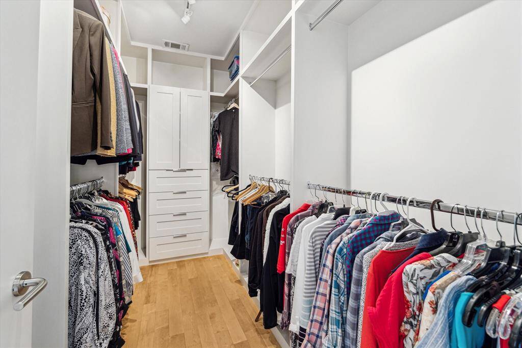 One of the two primary bedroom closets . Custom built-ins.