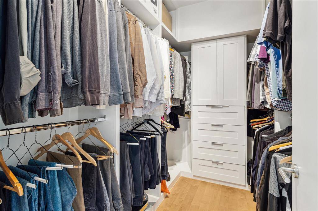 The second primary bedroom closet also with custom built-ins.