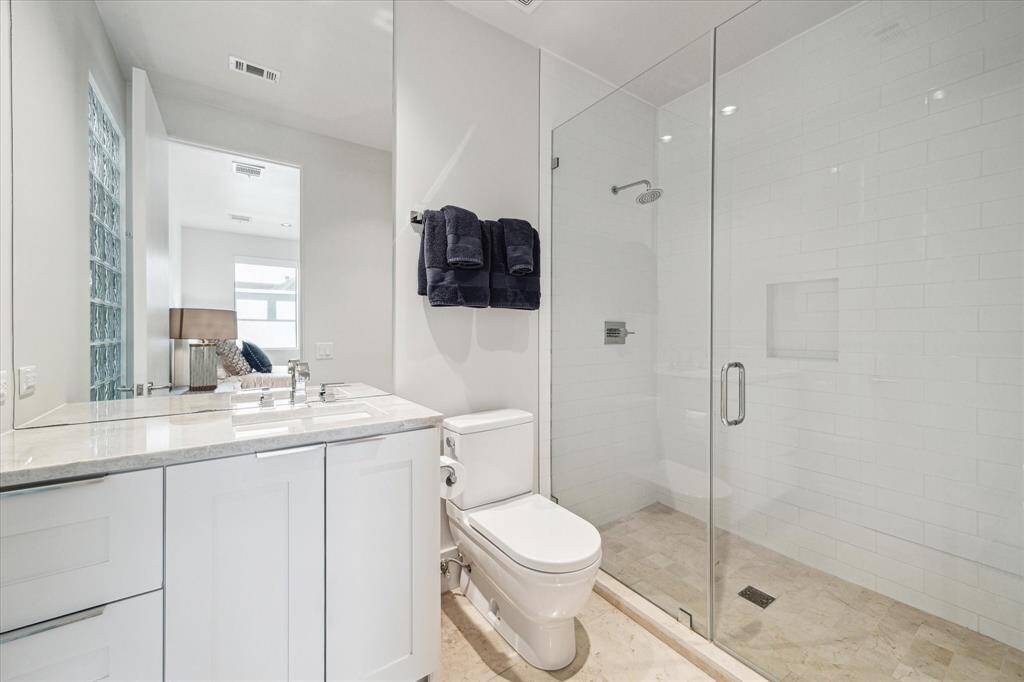 Third Bedroom Ensuite Bath - Carrera marble flooring. Custom tile. Kohler sink. Delta faucets. Stone Slab Countertop.